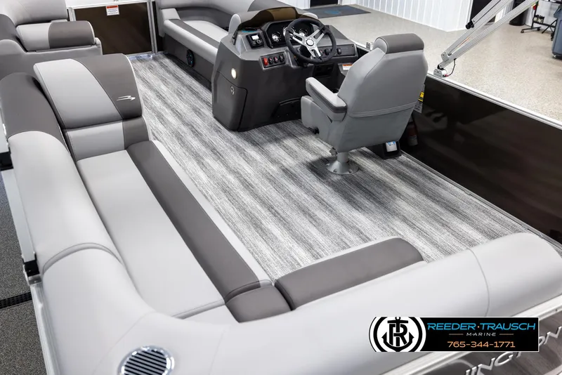 Slide: The Image of 2025 Bennington 21 SLSE pontoon boat interior with gray seating and modern helm. - 11