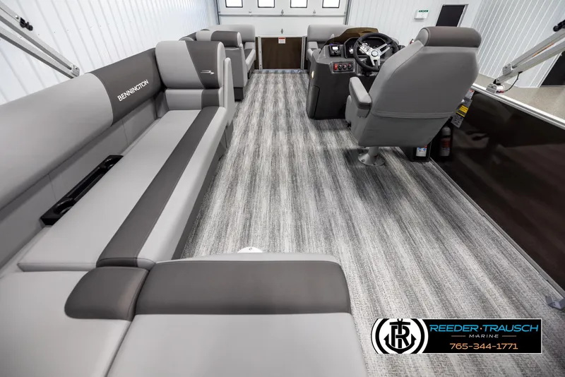 Slide: The Image of 2025 Bennington 21 SLSE pontoon boat interior with gray seating and modern dashboard. - 16