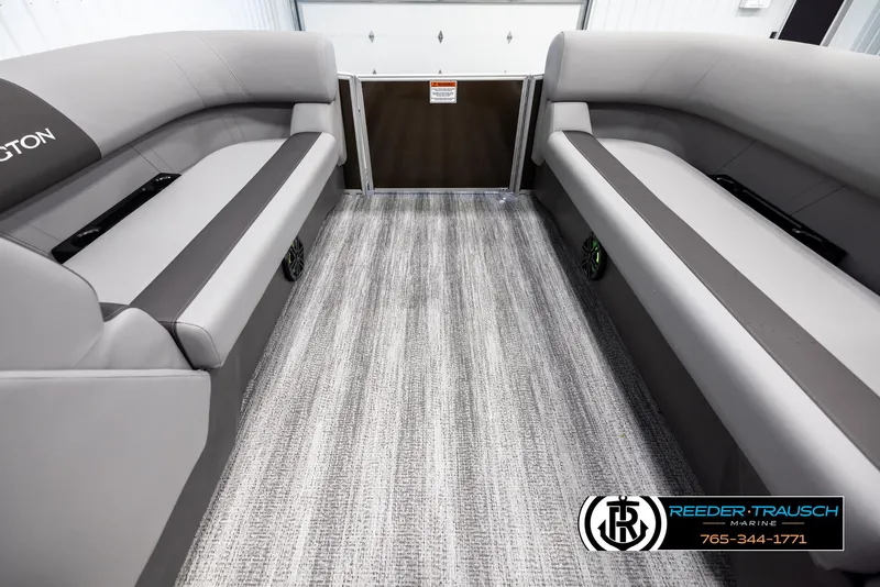 Slide: The Image of Interior of 2025 Bennington 21 SLSE pontoon boat with gray seating and carpet. - 18