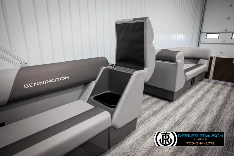 Slide: The Image of 2025 Bennington 21 SLSE boat interior with gray seating and storage compartment. - 21