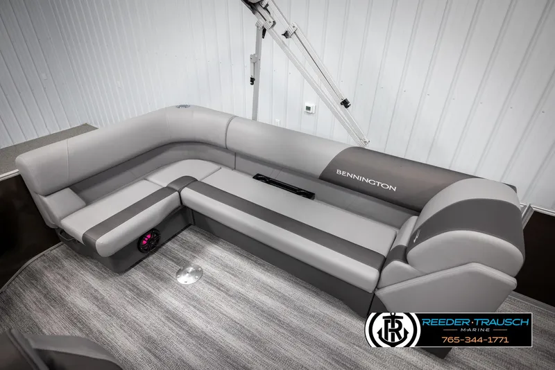 Slide: The Image of 2025 Bennington 21 SLSE pontoon boat interior with gray seating and carpeted flooring. - 22