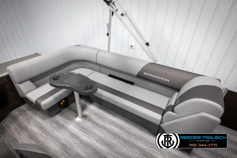 Slide: The Image of 2025 Bennington 21 SLSE pontoon boat interior with gray seating and table. - 23