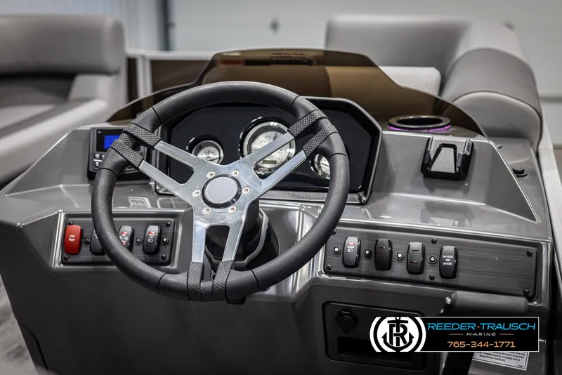Slide: The Image of 2025 Bennington 21 SLSE boat dashboard with steering wheel and control panel. - 26