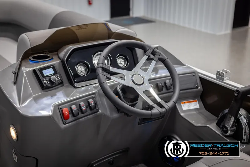 Slide: The Image of 2025 Bennington 21 SLSE boat dashboard with steering wheel and controls. - 27