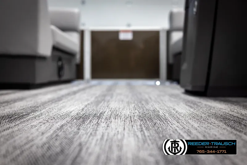 Slide: The Image of Interior view of 2025 Bennington 21 SLSE pontoon boat with carpet flooring. - 42