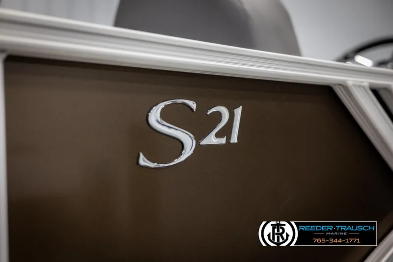 Slide: The Image of 2025 Bennington 21 SLSE boat, close-up of S21 emblem, Reeder-Trausch Marine branding. - 46