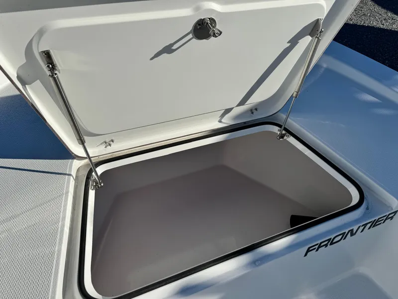 Slide: The Image of 2025 Frontier 2104 boat on trailer with Yamaha outboard motor, parked outdoors. - 10