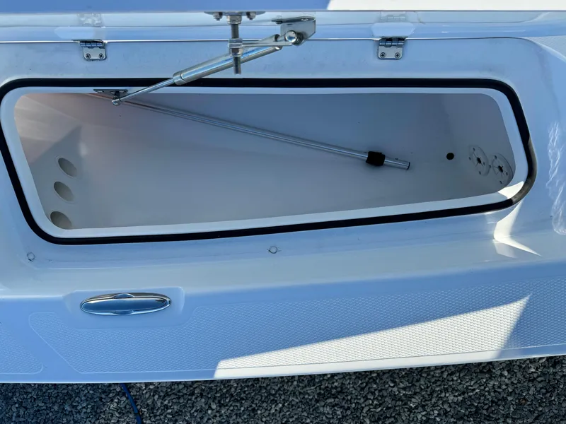 Slide: The Image of 2025 Frontier 2104 boat with 150 HP engine, parked outdoors under clear blue sky. - 12