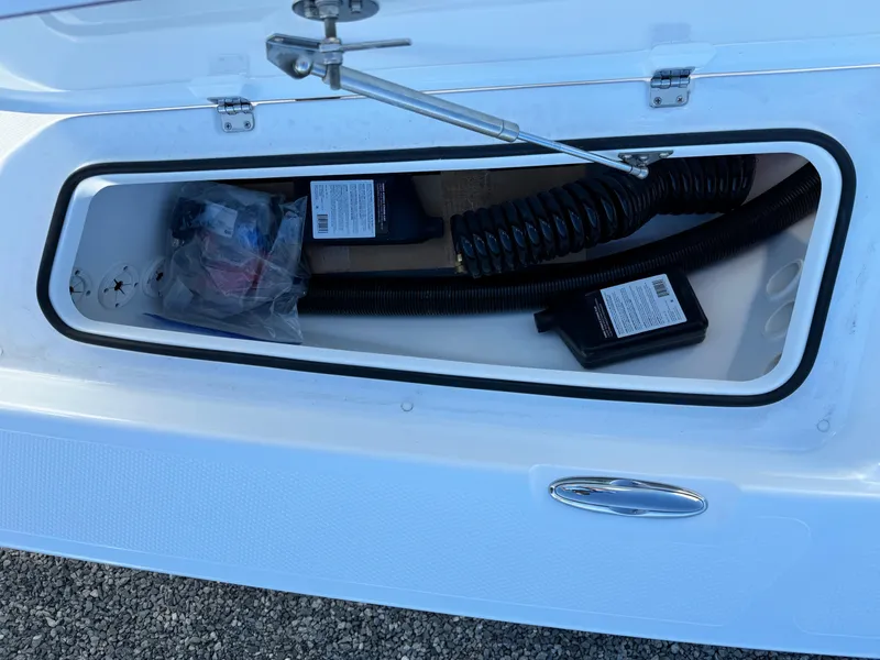 Slide: The Image of 2025 Frontier 2104 boat with Yamaha motor, parked outdoors at a marina. - 13