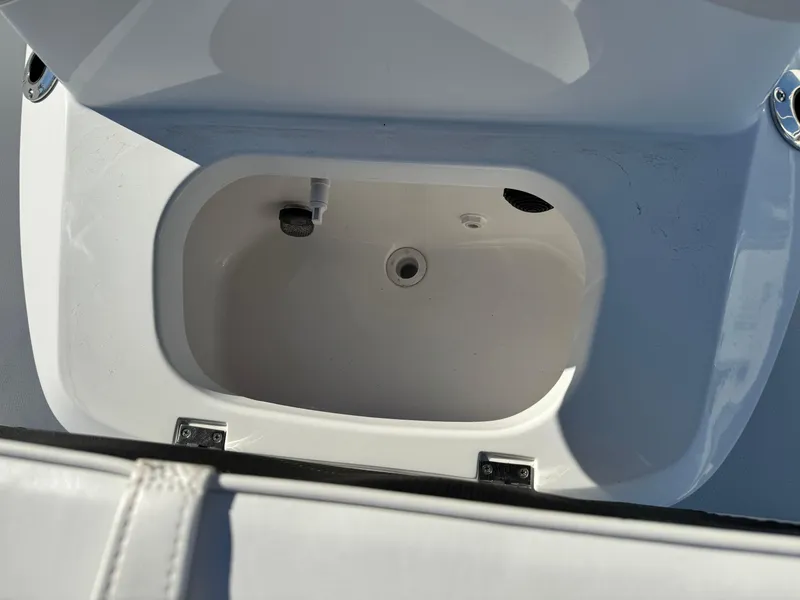 Slide: The Image of 2025 Frontier 2104 boat with sleek white deck and seating, parked outdoors. - 15