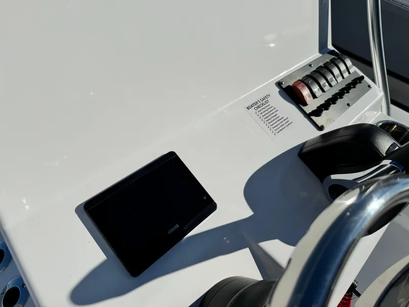 Slide: The Image of 2025 Frontier 2104 boat interior with seating and storage, displayed outdoors. - 20