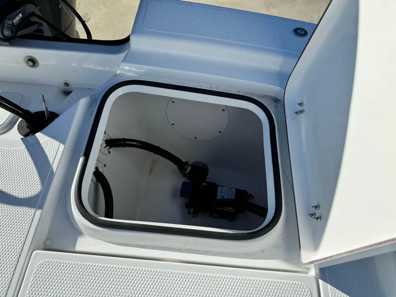 Slide: The Image of 2025 Frontier 2104 boat dashboard with Garmin navigation system and steering wheel. - 25