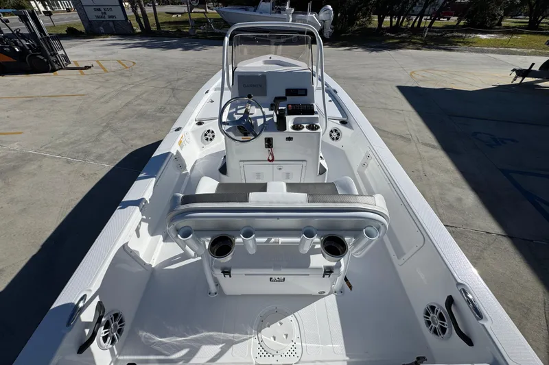 Slide: The Image of 2025 Frontier 2104 boat interior with steering console and seating, parked outdoors. - 29