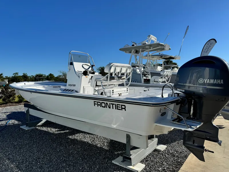 Slide: The Image of 2025 Frontier 2104 boat on trailer at a marina under clear blue sky. - 3