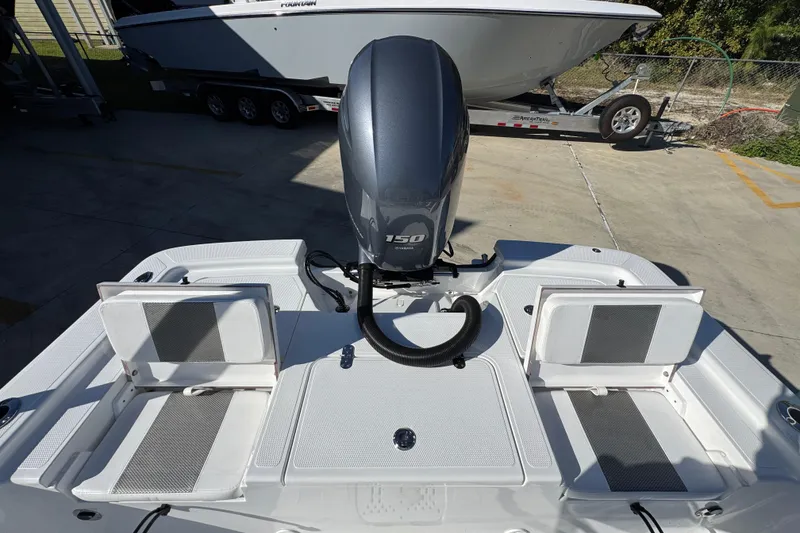 Slide: The Image of 2025 Frontier 2104 boat with 150 HP engine, featuring dual seating and storage compartments. - 30