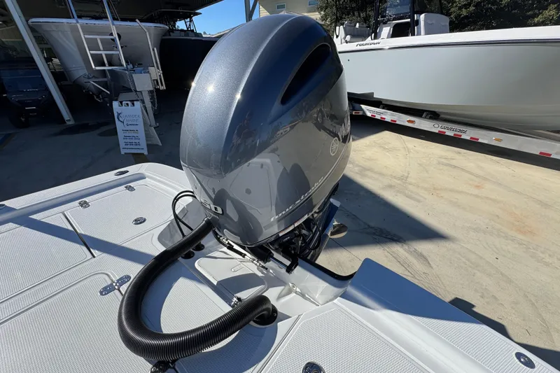Slide: The Image of Outboard motor on a 2025 Frontier 2104 boat, displayed outdoors. - 31