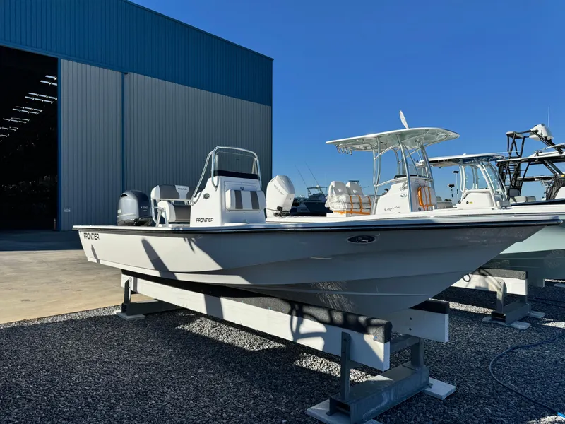 Slide: The Image of 2025 Frontier 2104 boat on trailer in sunny outdoor setting. - 7