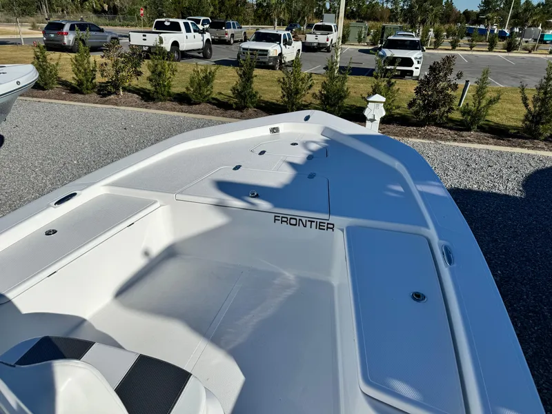Slide: The Image of 2025 Frontier 2104 boat on trailer, parked outdoors under clear blue sky. - 8