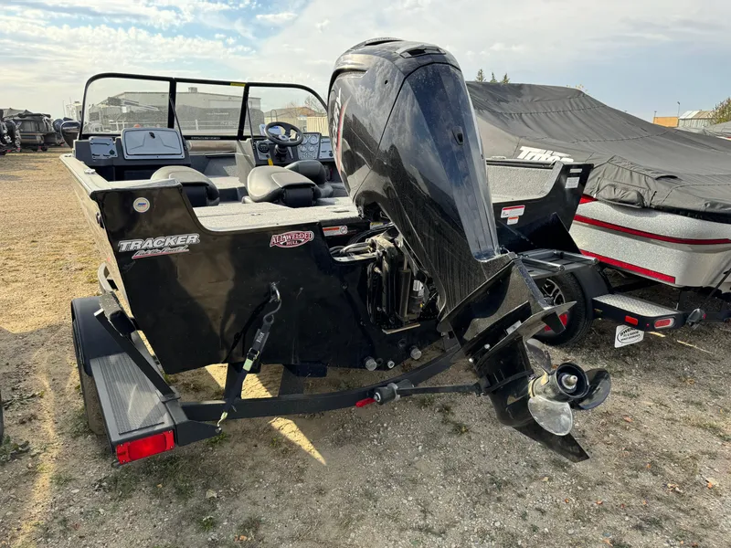 Slide: The Image of 2022 Tracker Pro Guide V-175 WT boat with powerful outboard motor, parked on a trailer. - 4