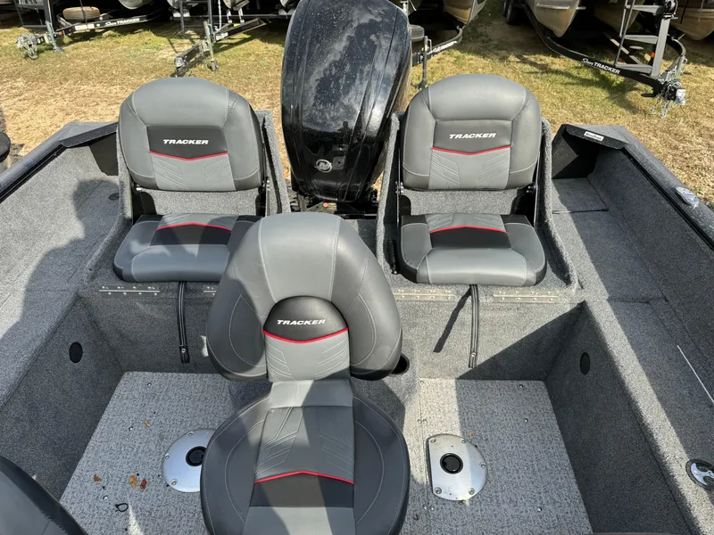 Slide: The Image of 2022 Tracker Pro Guide V-175 WT boat interior with three seats and motor. - 7