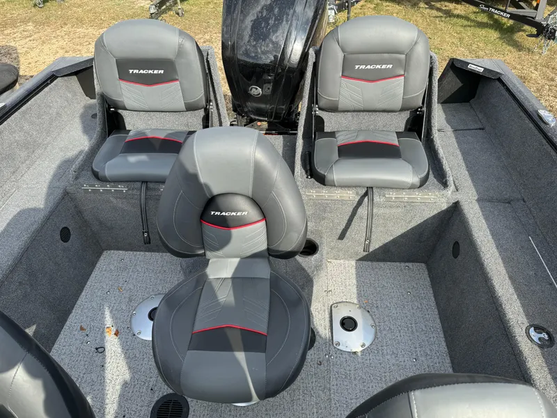 Slide: The Image of 2022 Tracker Pro Guide V-175 WT boat interior with gray seating and red accents. - 8