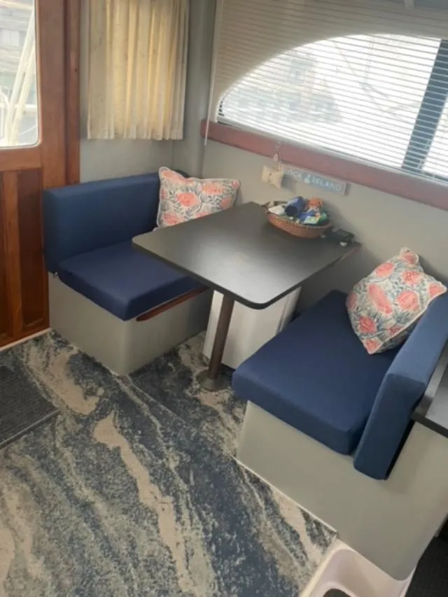 Slide: The Image of 1989 Luhrs 320 Tournament interior with blue seating and patterned cushions. - 11