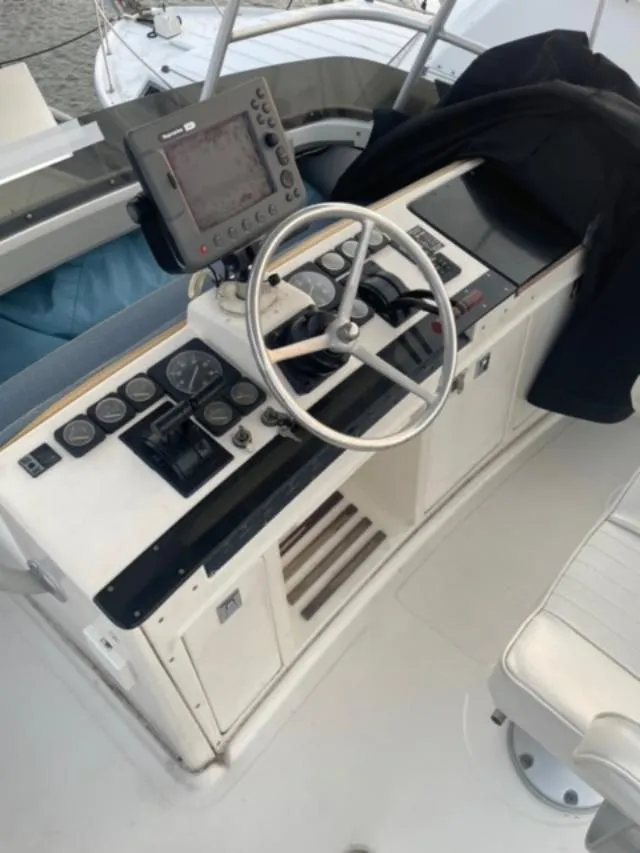 Slide: The Image of 1989 Luhrs 320 Tournament helm with steering wheel and navigation equipment. - 6