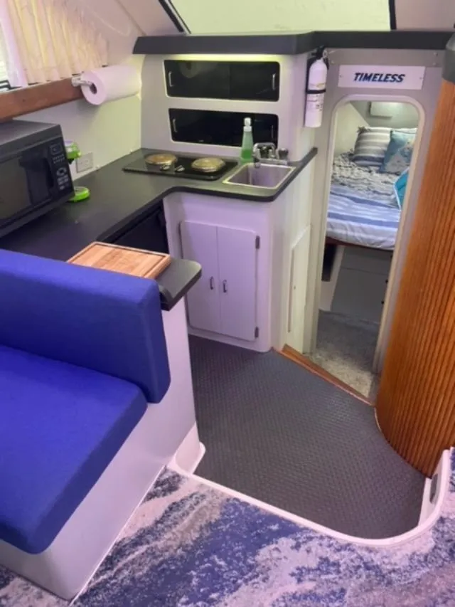 Slide: The Image of Interior of 1989 Luhrs 320 Tournament boat with kitchenette and cozy sleeping area. - 14