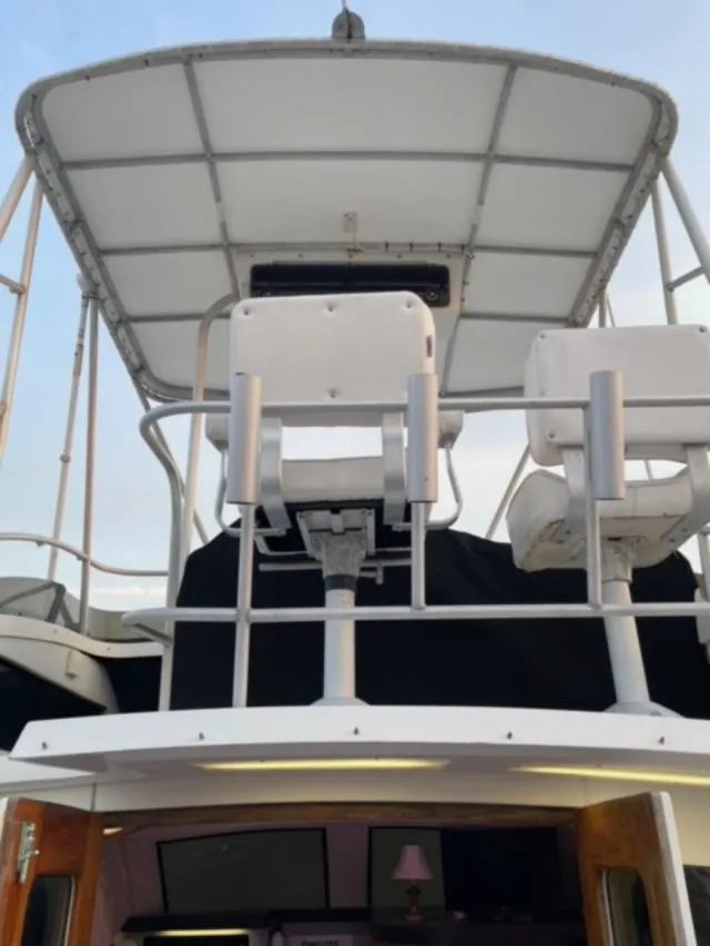 Slide: The Image of 1989 Luhrs 320 Tournament boat with upper deck seating and canopy. - 5