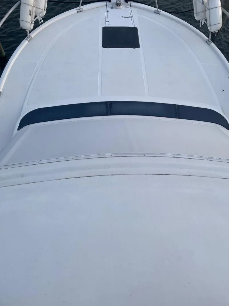 Slide: The Image of 1989 Luhrs 320 Tournament boat deck, aerial view, white surface, sleek design. - 3