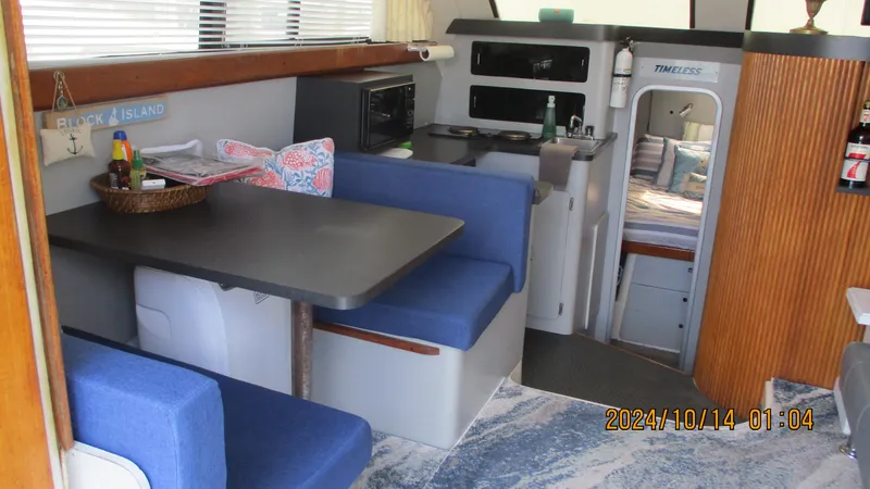 Slide: The Image of Interior of 1989 Luhrs 320 Tournament boat with dining area and cabin. - 17