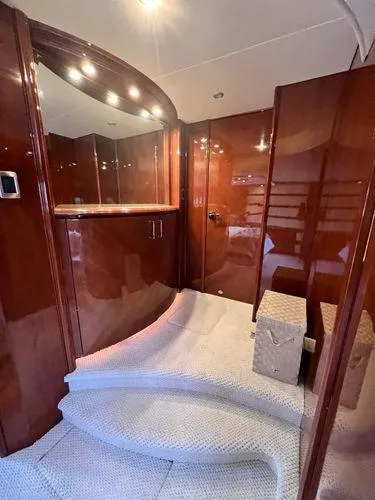 Slide: The Image of Luxurious interior of 2005 Marquis 65 yacht with polished wood and carpeted steps. - 13