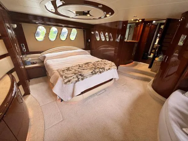 Slide: The Image of Luxurious 2005 Marquis 65 yacht bedroom with elegant wood finishes and plush bedding. - 14