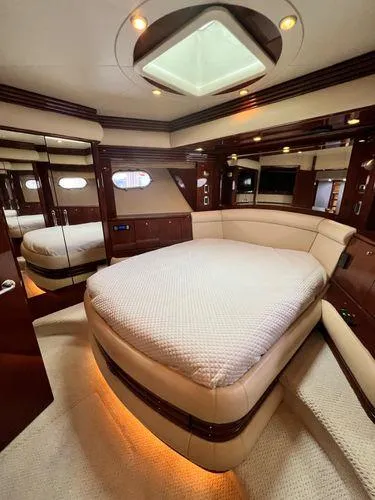 Slide: The Image of Luxurious 2005 Marquis 65 yacht bedroom with elegant wood finishes and ambient lighting. - 15