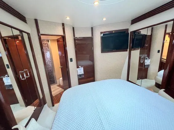 Slide: The Image of Luxurious interior of a 2005 Marquis 65 yacht bedroom with modern amenities. - 16
