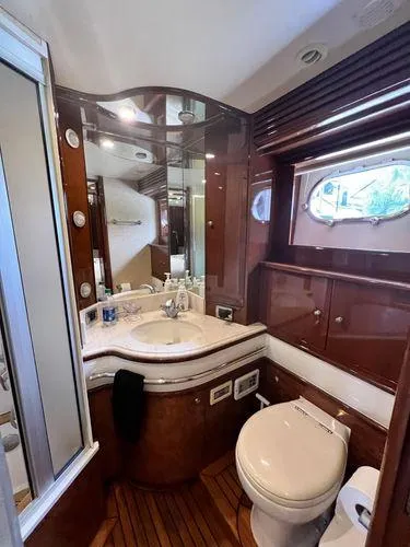 Slide: The Image of Luxurious 2005 Marquis 65 yacht bathroom with elegant wood finishes and modern fixtures. - 18