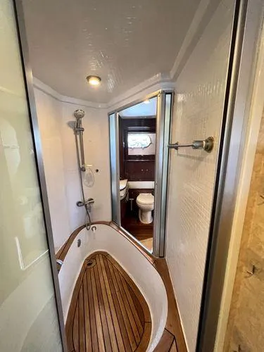 Slide: The Image of Luxurious bathroom in 2005 Marquis 65 yacht with wooden flooring and modern fixtures. - 19