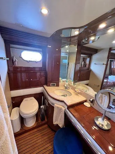 Slide: The Image of Luxurious 2005 Marquis 65 yacht bathroom with elegant wood finishes and modern amenities. - 20