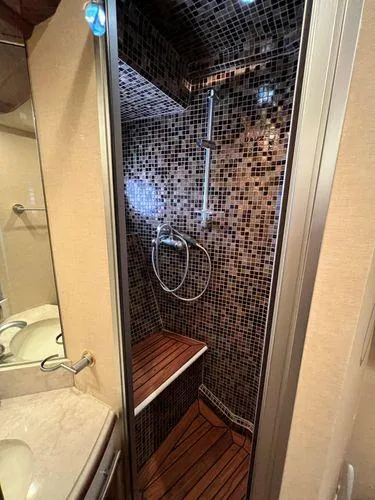 Slide: The Image of Luxurious 2005 Marquis 65 yacht shower with mosaic tiles and wooden floor. - 22