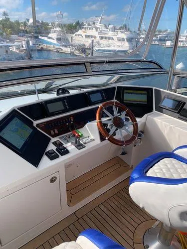 Slide: The Image of 2005 Marquis 65 yacht helm with modern navigation equipment and luxurious seating. - 27