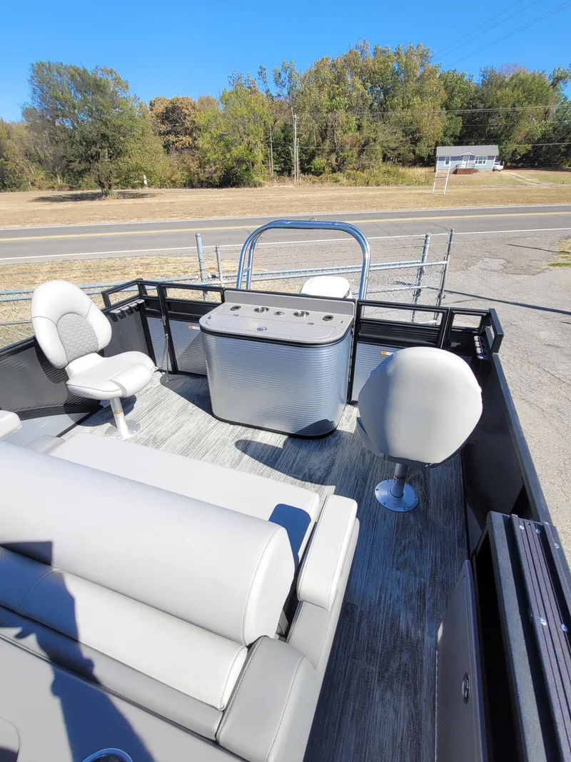 Slide: The Image of 2025 Quest M-8524 Angler Series boat interior with seating and console, parked near road. - 10