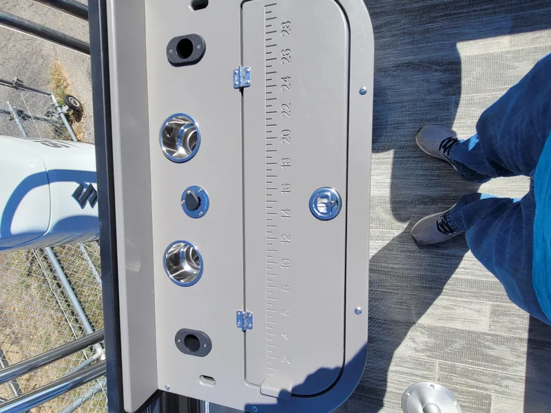 Slide: The Image of 2025 Quest M-8524 Angler Series boat deck with built-in measuring tool and cup holders. - 13