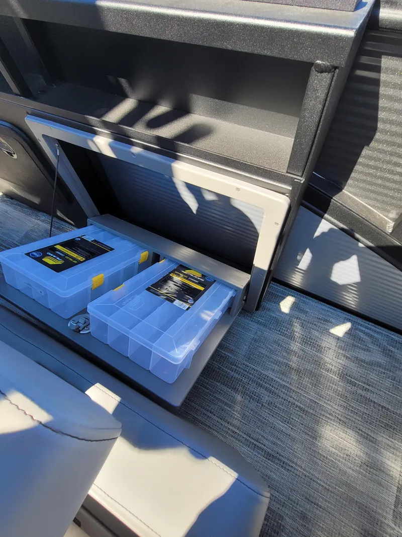 Slide: The Image of Storage compartment in 2025 Quest M-8524 Angler Series boat with tackle boxes. - 18