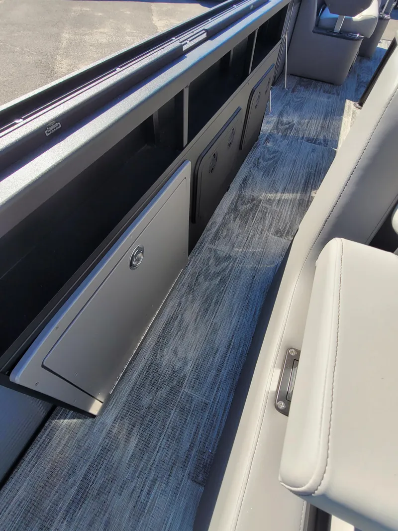 Slide: The Image of 2025 Quest M-8524 Angler Series boat interior with sleek storage compartments and modern seating. - 19
