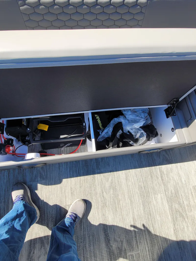 Slide: The Image of 2025 Quest M-8524 Angler Series boat storage compartment with gear and equipment. - 21