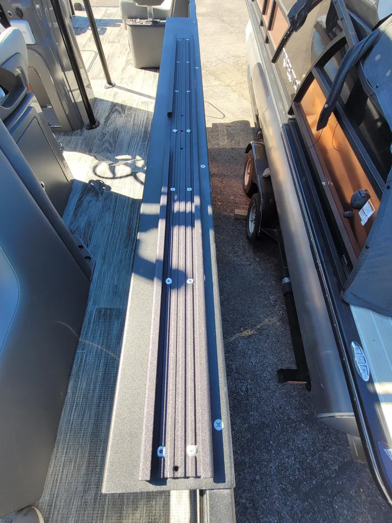 Slide: The Image of 2025 Quest M-8524 Angler Series boat deck with seating and storage. - 23