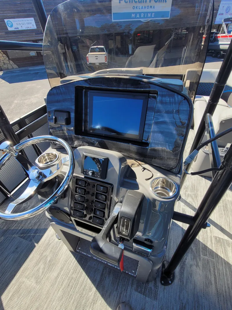 Slide: The Image of 2025 Quest M-8524 Angler Series boat console with steering wheel and control panel. - 25