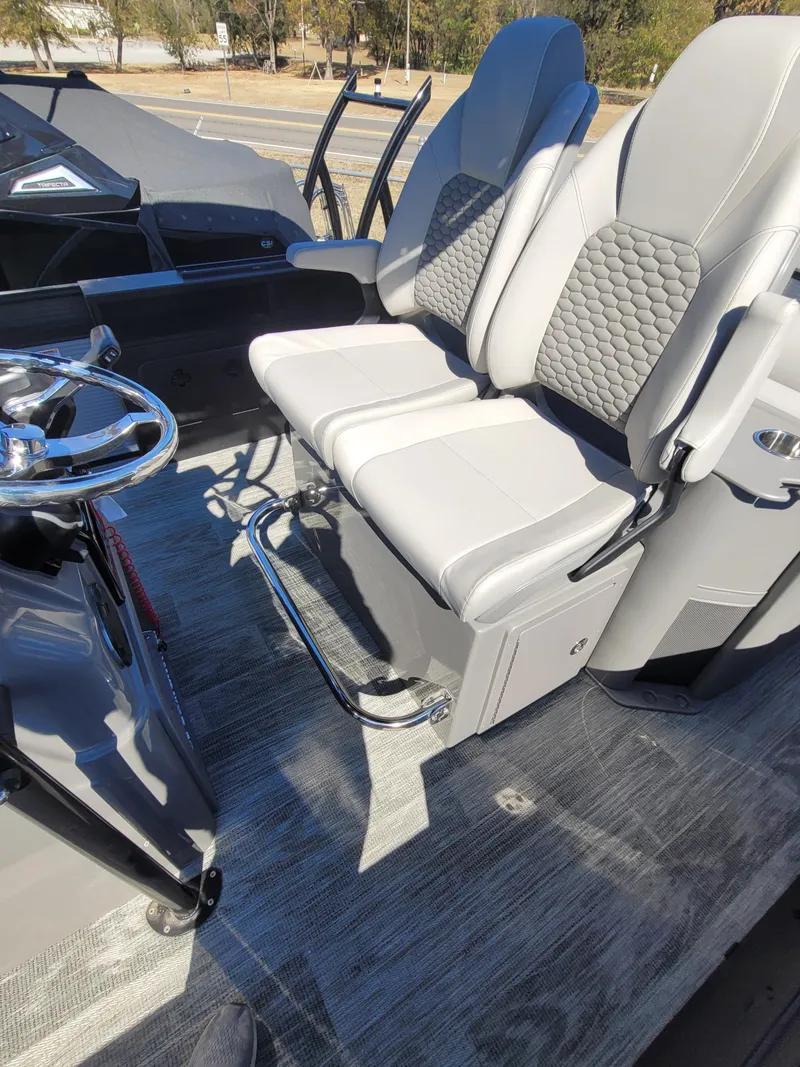 Slide: The Image of 2025 Quest M-8524 Angler Series boat interior with gray seating and steering wheel. - 28