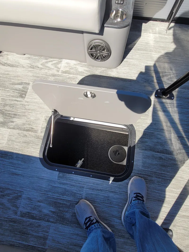 Slide: The Image of 2025 Quest M-8524 Angler Series boat interior with open storage compartment. - 29