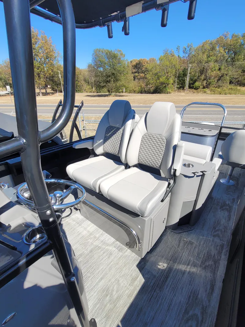 Slide: The Image of 2025 Quest M-8524 Angler Series boat interior with dual seats and steering wheel. - 9